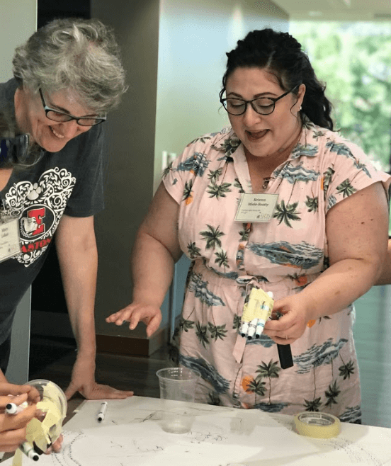 Two educators participating in a professional development program by making scribble bots.